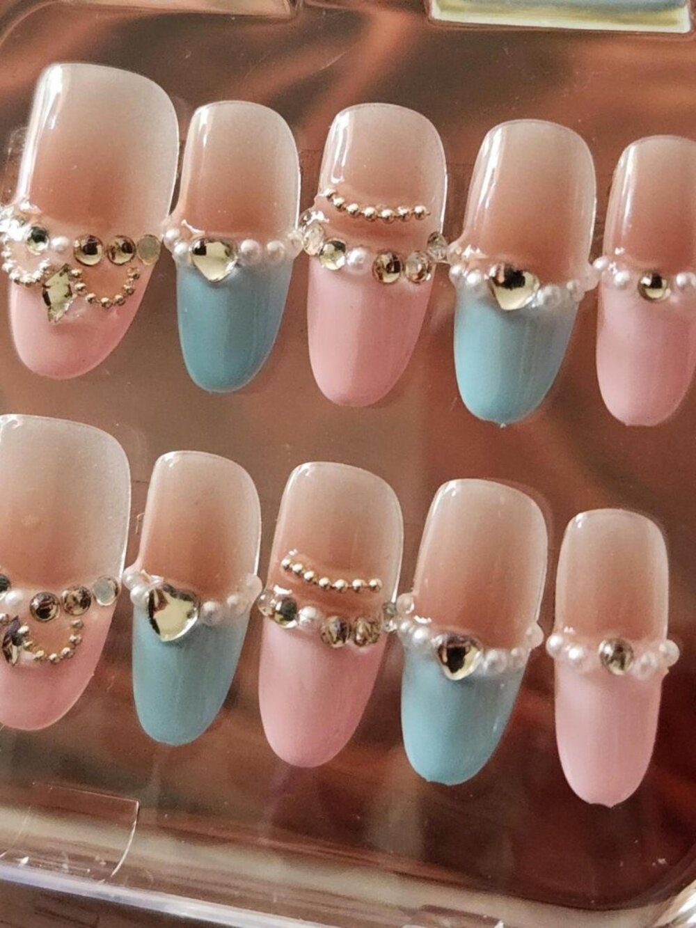 2.5 Pink & blue oval french-tip press-on nails w/ rhinestone hearts & pearls.